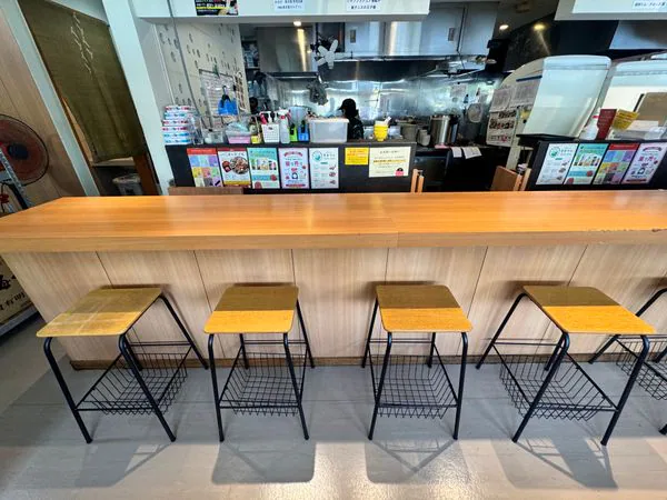 沖縄やまやの窓際カウンター席とテーブル席がある店内