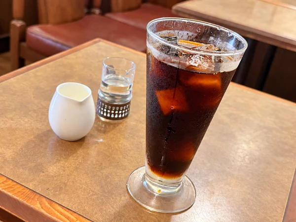 珈琲の館で注文した450円の水出しアイスコーヒー。氷の入った背の高いグラスに注がれた濃い色のコーヒー
